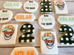 decorated cookies with numbers and sports related items for birthdays on a wooden table top