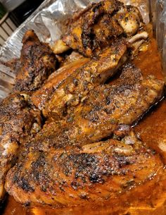 some meat is sitting on tin foil and ready to be grilled in the oven