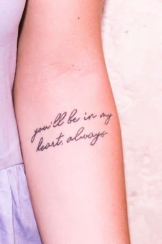 a woman with a tattoo on her arm that says, you're in my heart always