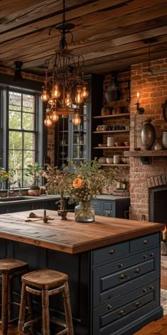 an old fashioned kitchen with brick walls and wood flooring, large center island in the middle