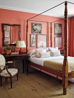 a bedroom with pink walls and white bedding