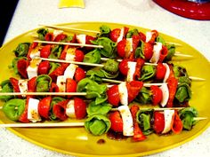 several skewered vegetables on a yellow plate