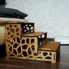 three wooden boxes sitting on top of a hard wood floor