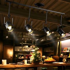 an image of a restaurant setting with food on the table and lights hanging from the ceiling