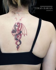 a woman with a dragon tattoo on her back