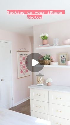 a room with pink walls and white furniture