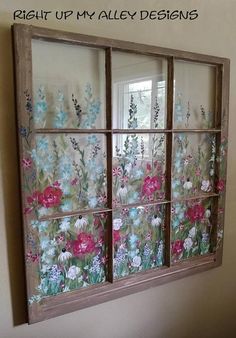 an old window with flowers painted on the glass is shown in this photo, and there are