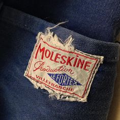 a patch on the back of a blue jean jacket that says moloskine