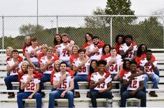 a group of people sitting on top of a bleachers next to each other