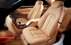 the interior of a car is shown with beige leather and black trims on it