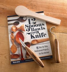 spoons, bowls and a knife sitting on top of a book