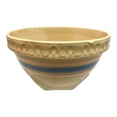 a white bowl with blue, pink and yellow stripes on the rim is sitting in front of a white background