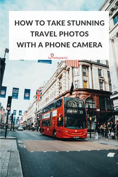 a red double decker bus driving down a street next to tall buildings with the words how to take stunning travel photos with a phone camera