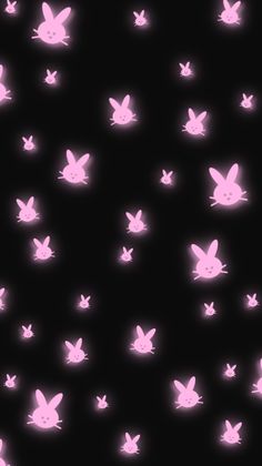 some pink rabbits on a black background with white lights in the shape of small stars