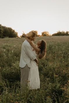 a man holding a woman in a field