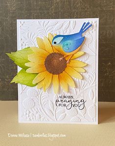 a blue bird sitting on top of a sunflower next to a white card that says always greeting for you