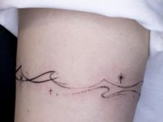 a woman's arm with a small star tattoo on the left side of her leg