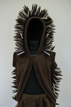 a hoodie with spikes on the front and back is made out of brown material