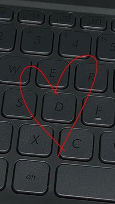 a computer keyboard with a heart drawn on it