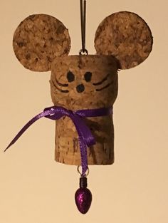 a wine cork ornament with a mouse head on it