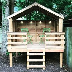 a wooden structure with green chairs on it