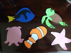 cut out sea animals are displayed in a shadow box