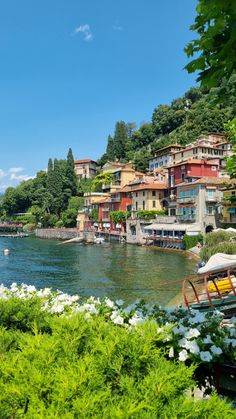 houses on the shore of a lake surrounded by greenery