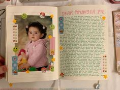 an open children's book with pictures and words on the pages that include a baby