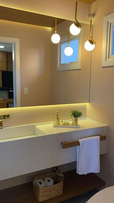 a bathroom with a sink, mirror and lights