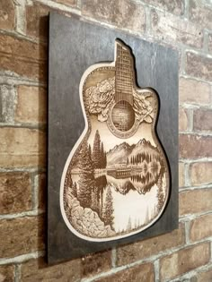 an acoustic guitar is mounted on a brick wall next to a wood burning fireplace mantel