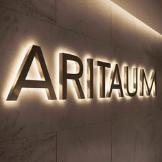 an illuminated sign on the side of a building that reads,'ariaum '