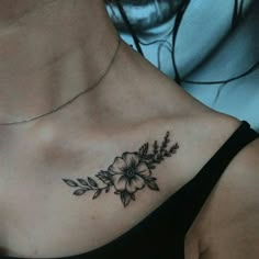 a woman with a flower tattoo on her chest