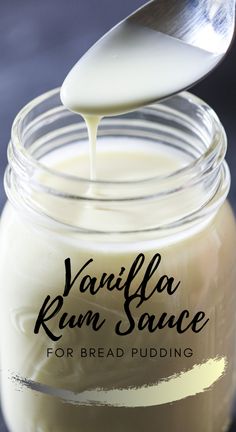 vanilla rum sauce for bread pudding in a glass jar with a spoon sticking out of it