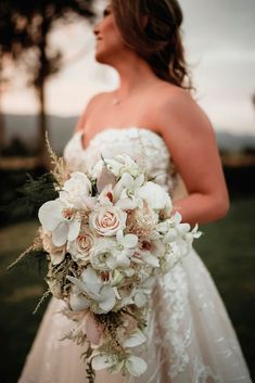 a woman in a wedding dress holding a bouquet