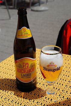 a beer bottle and glass sitting on a table