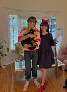 the man and woman are posing with their cats