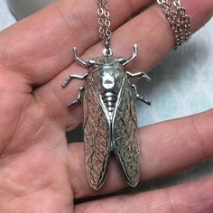 "Large cicada bug made of solid brass with silver plating and a locket hidden on the reverse side! Beautiful detail on this 2\" bug that is made with vintage molds that are nearly 100 years old. A truly unique necklace. Perfect gift for the bug lover! The locket is silver plated and in a tear drop shape. It can hold a special sentiment or tiny image. Check out this same locket in brass: https://www.etsy.com/listing/554860158/hidden-locket-necklace-cicada-large?ref=shop_home_active_6&pro=1&am Insect Jewelry Paper, Insect Jewelry Inspire Uplift ⭐, Insect Jewelry Necklaces, Differentbugs Necklace, Secret Compartment Necklace, Insect Jewelry Design, Unique Locket Necklace, Cicada Necklace, Bug Necklace