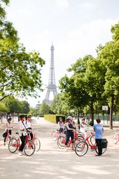 several people on bicycles with the eiffel tower in the background