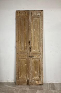 an old wooden double door in a white room