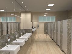 a row of sinks and mirrors in a bathroom with wood flooring on the walls