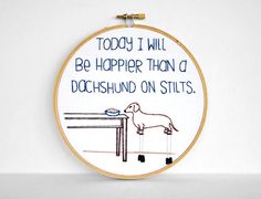 there is a embroidery on the wall that says today i will be happier than a dachshund on stilts