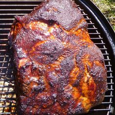 a steak is cooking on the grill outside