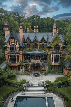 an aerial view of a large house with a pool in the front yard and lots of greenery