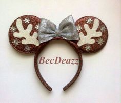 a minnie mouse ears with silver and white snowflakes on it