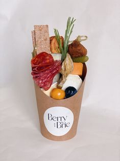 a paper cup filled with different types of food