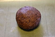 a chocolate muffin sitting on top of a counter