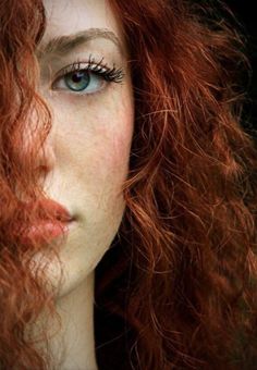 a woman with red hair and blue eyes