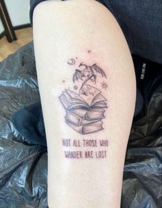 a woman's leg with a tattoo that reads, not all those who wander are lost