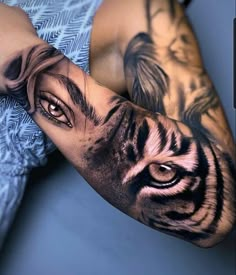 a man's arm with a tiger tattoo on it and his eyes are open