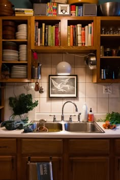 a kitchen with wooden cabinets and bookshelves filled with cookbooks on the shelves